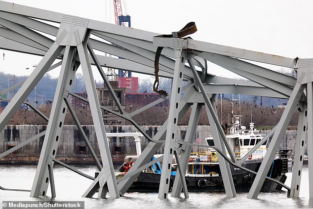 On Sunday, diving teams inspected parts of the bridge and searched the ship, and workers on the elevators used blowtorches to cut above-water parts of the twisted steel superstructure.
