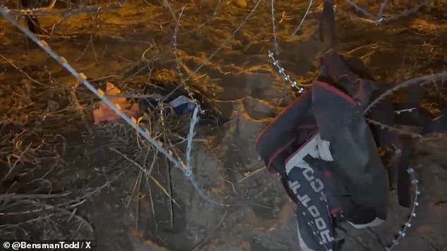 Clothes and other items are caught in dangerous barbed wire that migrants cross to reach the border wall and cross illegally into the US.