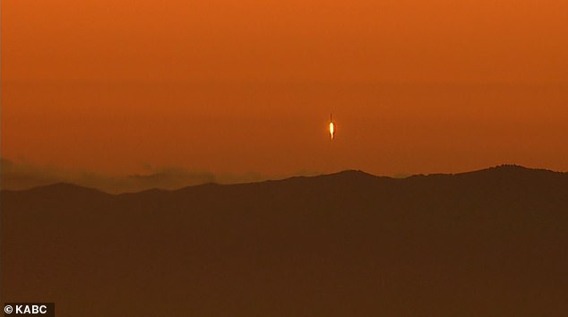 You can see the rocket taking off with the mountains in the distance.
