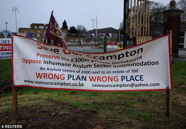 A protest banner is seen at a protest camp outside the main entrance to RAF Scampton, the former home of the British Red Arrows and Dambusters squadron