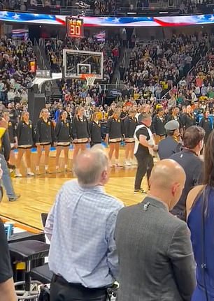 Iowa players listened to the US national anthem before their game against LSU