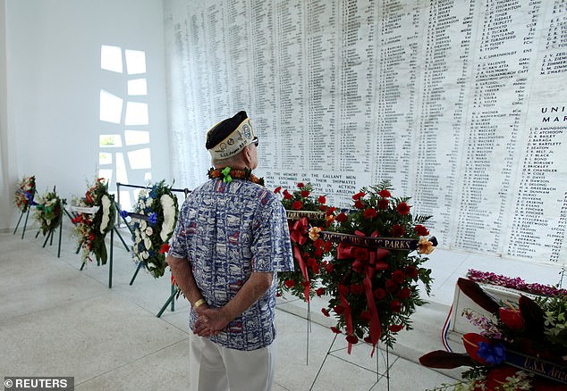He retired in 1967 after serving 28 years in the United States Navy.  (pictured: Conter looking at the names of the sailors who died at Pearl Harbor)