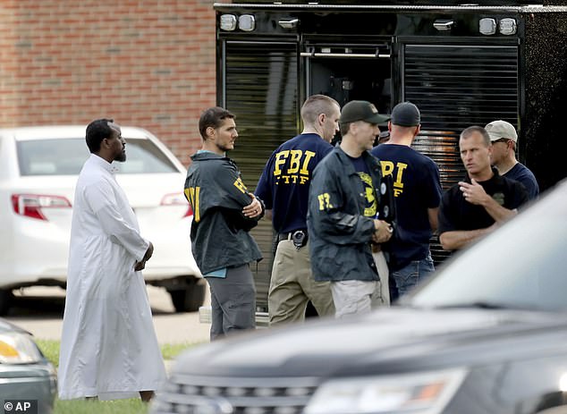 Hari was found guilty of all five charges, which include use of explosives, damaging property due to his religious character and obstruction of the free exercise of religious beliefs. Pictured: FBI agents at the scene in August 2017.