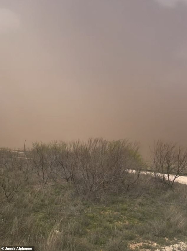 In Texas, a furious dust storm swept over the land and turned the skies an ominous shade of red and gray, with only a few white clouds still visible in the distance.