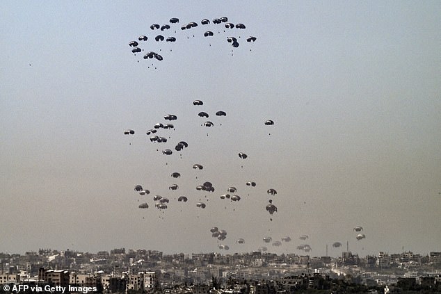 This photograph taken from Israel's southern border with the Gaza Strip shows humanitarian aid being airdropped over the besieged Palestinian territory on April 2.