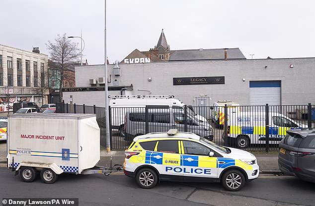 A police officer parked with a major incident unit outside a branch of Legacy Independent Funeral Directors on Hessle Road in Hull