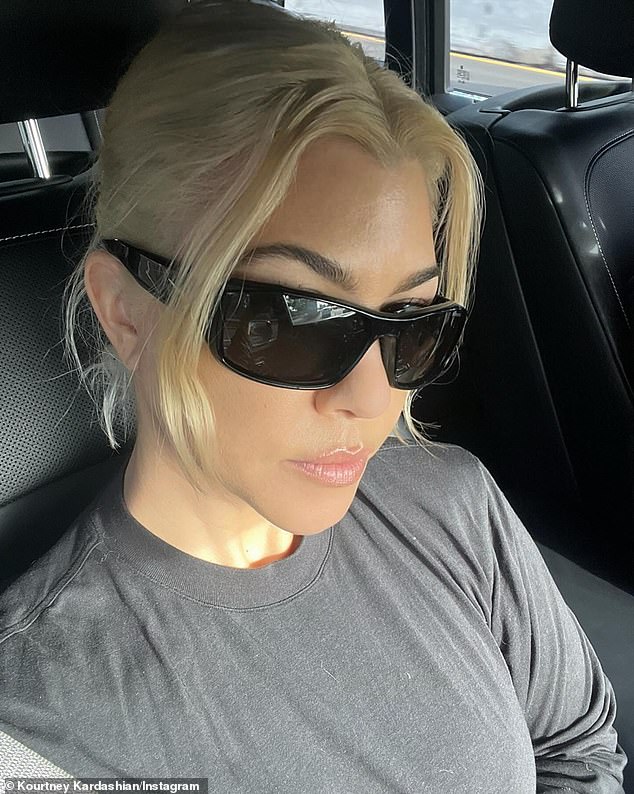 The model kept it casual as she sat in her car to take a selfie. Kardashian wore a gray long-sleeved t-shirt with a crew neck. Her locks were pulled back into a short ponytail and she wore natural-looking makeup with soft pink lips and dark sunglasses.