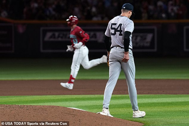 D'Backs first baseman Christian Walker runs the bases after hitting a three-run home run while facing Yankees relief pitcher Jake Cousins.