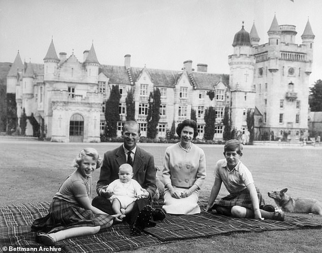 Queen Elizabeth II and Prince Philip, Duke of Edinburgh, with their children Prince Andrew (centre), Princess Anne (left) and Charles, Prince of Wales (right), sitting on a picnic mat outside the Balmoral Castle in Scotland, September 8, 1960.