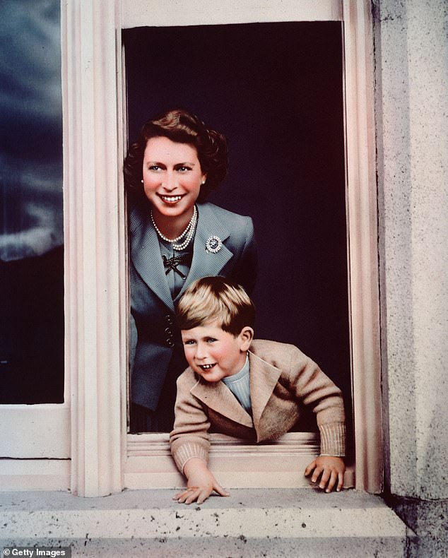 Prince Charles and his mother, Princess Elizabeth, looking out of a window at Balmoral in 1952.