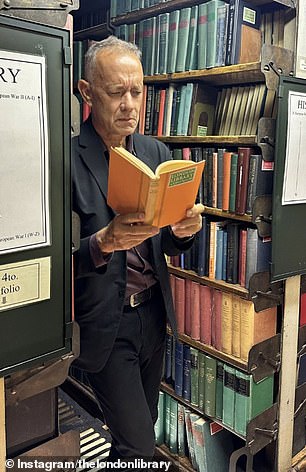 Tom Hanks seemed captivated as he read a book