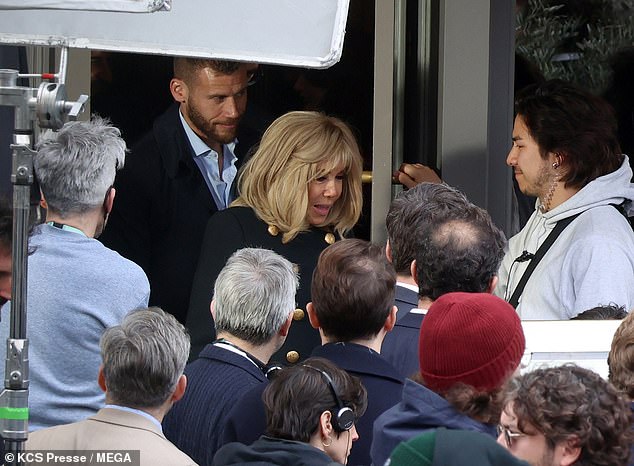 Macron was surrounded by cast and crew on set as she got to work.