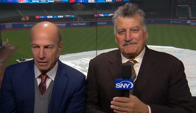 Cohen's expression drops the moment he thinks he's off camera during Tuesday's rain delay.