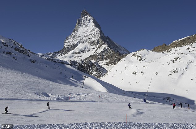 Skiers descend the slopes of Riffelberg with the Matterhorn in the background, 2012