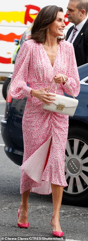 The 51-year-old monarch completed her ensemble with a white clutch and accessorized with chic pearl earrings.