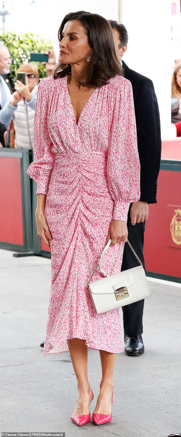 The mother-of-two wore an elegant pink and white floral ruched dress which she teamed with electric pink heels.