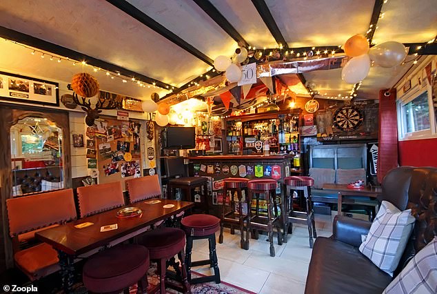 Within the property's garden shed there is a well-equipped pub with bar stools, darts board and a fully stocked drinks display.