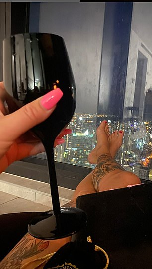 The 'shamanic goddess' having a glass of wine with her spectacular view of Surfers Paradise