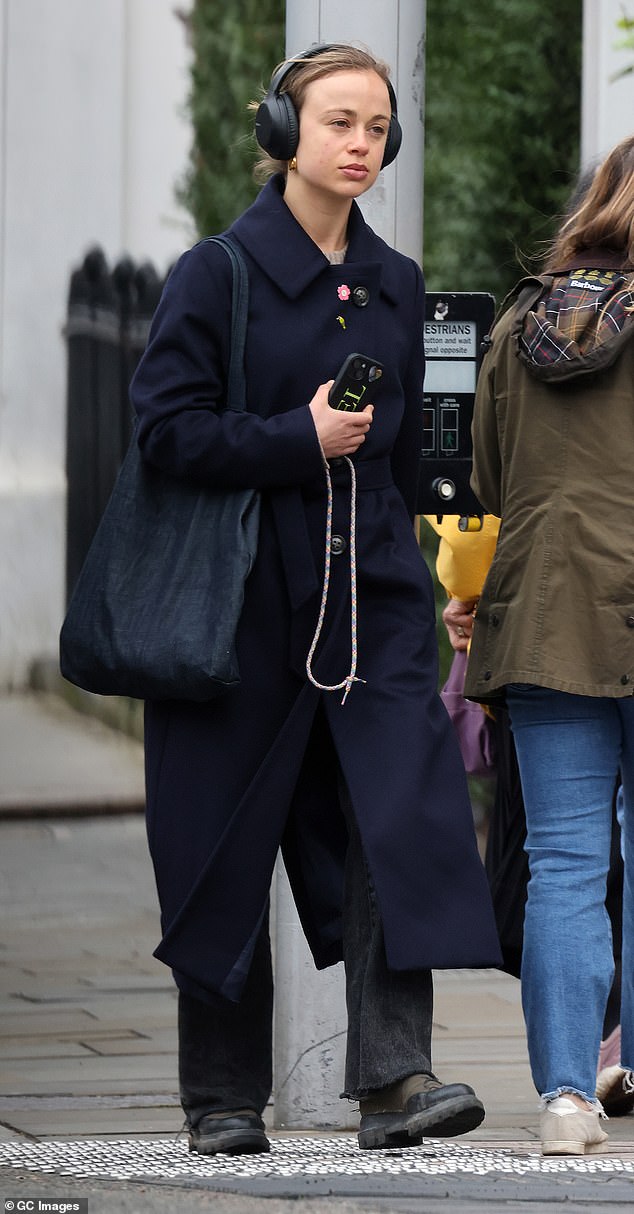 The model, granddaughter of the Duke of Kent, donned an elegant navy blue wool coat.