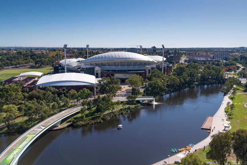 Adelaide Oval with River Torrens and footbridge with green signage