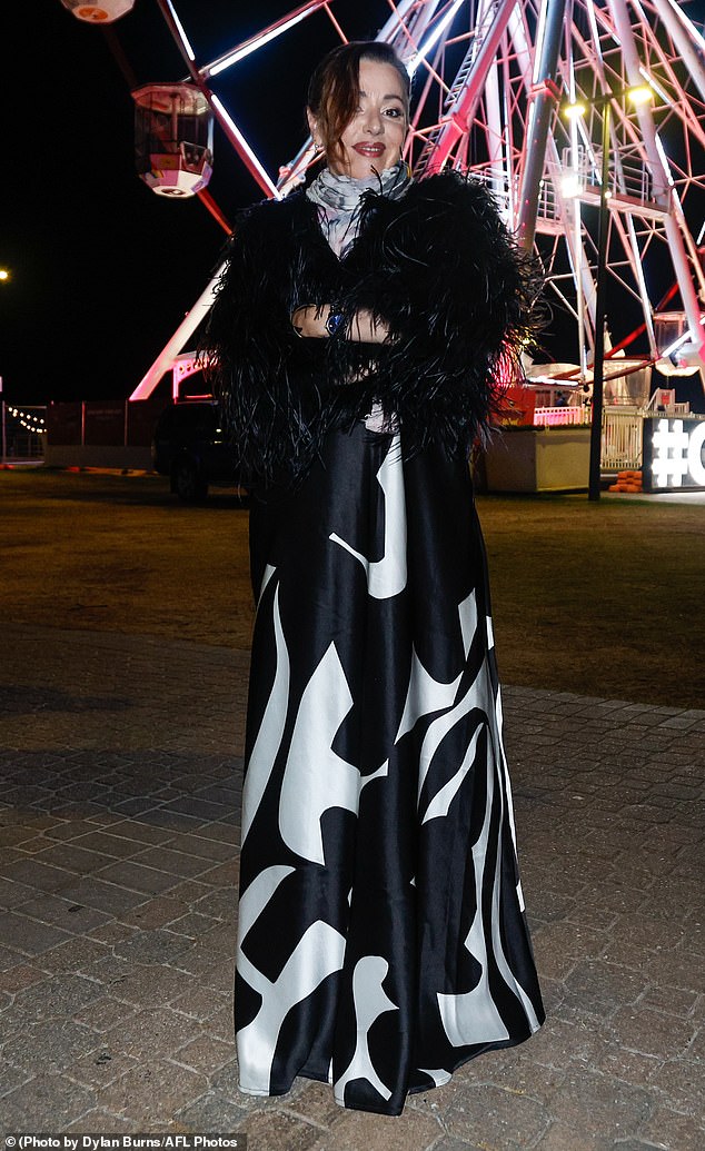 She donned a gorgeous black and white satin dress with extravagant feather puff sleeves.