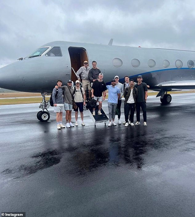 Lions players are seen posing in front of the private jet they used in the US, with board member Cathie Reid's partner Stuart Giles pictured left, top row of the stairs.