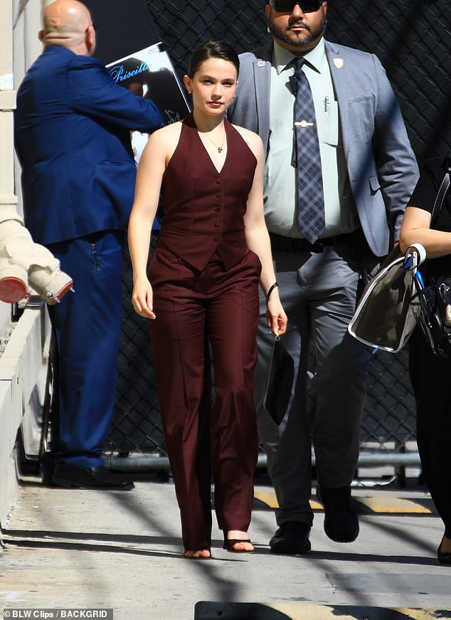 She finished her look with a pair of maroon pants and black heels as she headed to the studio.