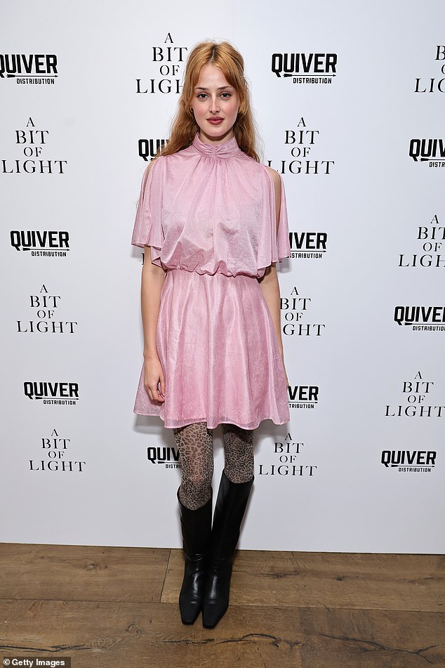Actress Anna Van Patten lightened the look with a pale pink minidress cinched at the waist, paired with leopard print tights and knee-high black boots.