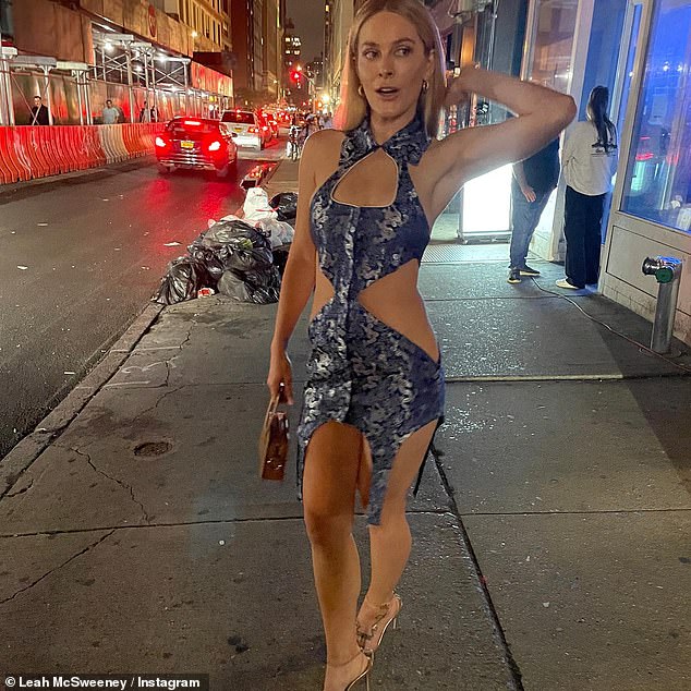 The reality star and designer poses on the trash-filled streets of New York.