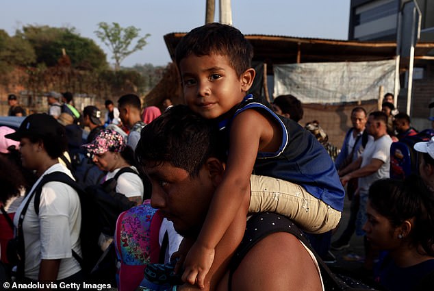 Migrant child gives a soft smile on his walk through Mexico to the border with the United States