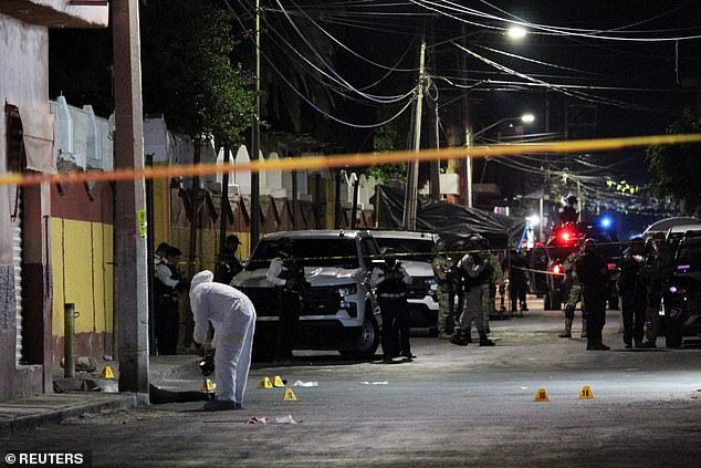 A forensic technician works at the place where the candidate for mayor of Celaya for the ruling Morena party, Gisela Gaytán, was shot dead on Tuesday