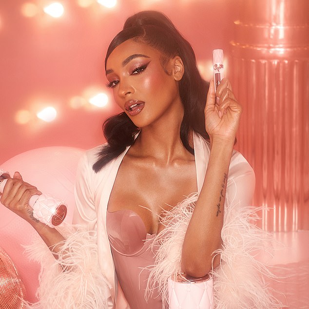While Jourdan, 33, oozed glamor as she showed off her ample cleavage in a low-cut pink corset and flowing feather robe.