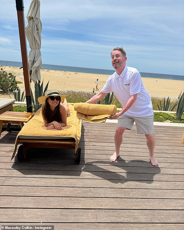In another shot, Culkin is seen presenting a towel to his partner as she relaxes in a beach chair.
