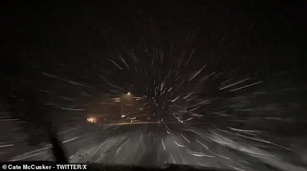 A tunnel of snow was seen hitting a driver's windshield on a dark highway in Maine as the streets filled with sleet.