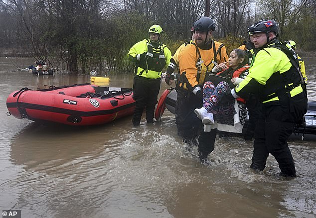 A woman is rescued in Franklin Township, Pennsylvania, by emergency crews after her home flooded.