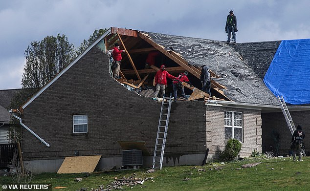 A gaping hole is seen in the roof of a home after strong tornadoes hit parts of southern Indiana and Louisville on Wednesday.