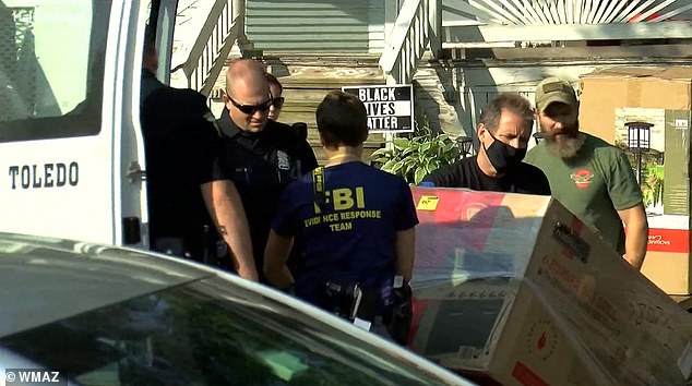The FBI photographed raiding the home and removing furniture from inside.