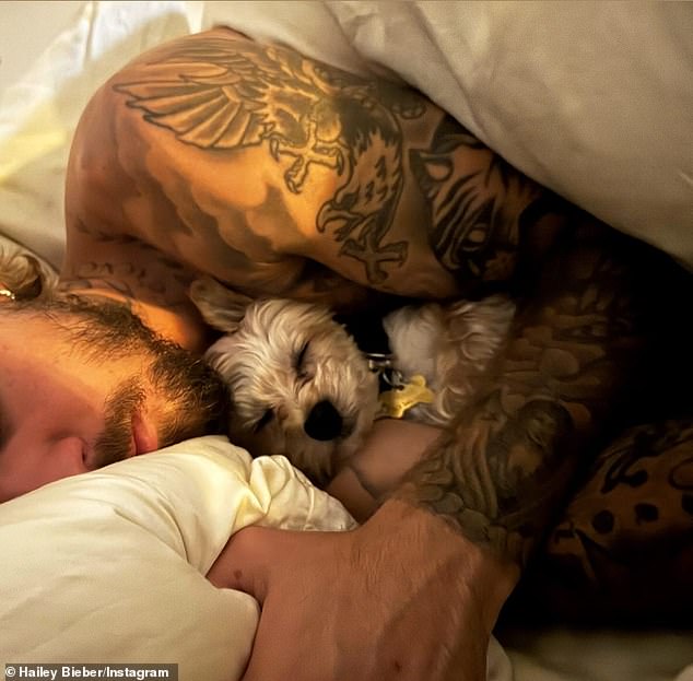 The Rhode founder, 27, also posted a shirtless photo of her husband Justin Bieber sleeping in bed with one of their two white Yorkshire Terriers on Instagram.