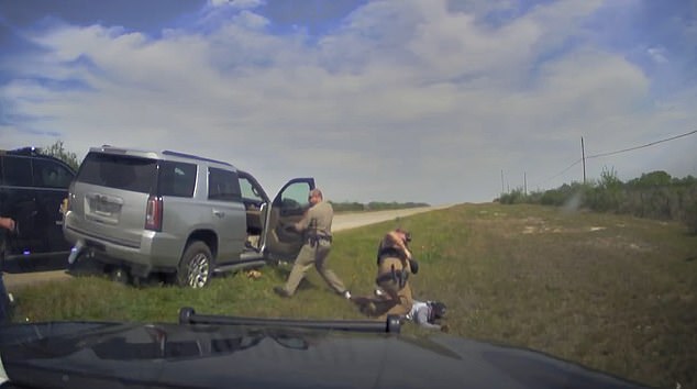 Johnson, a member of the Texas National Guard, is handcuffed as the officer reprimands him for the high-speed chase.