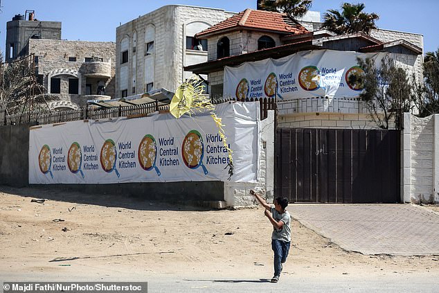 A Palestinian child plays in front of the closed World Central Kitchen headquarters two days after a convoy of aid workers was attacked in an Israeli strike in Gaza.