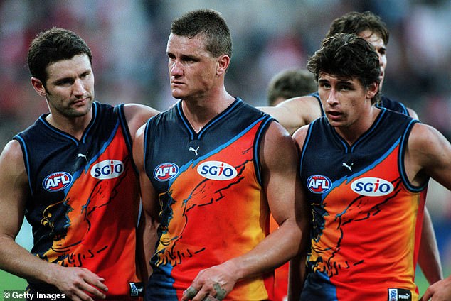 Teammates comfort Glen Jacovich (center) as the West Coast Eagles lost their 200th game in 2000. To add insult to injury, they wore a widely criticized hyper-colored jersey.