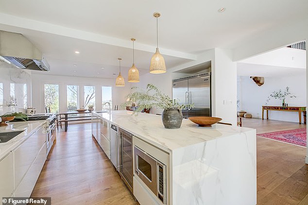 The extensive estate also features a stylish minimalist open kitchen with plenty of sunlight.