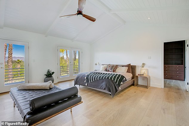 One of seven bedrooms located on the second floor of the home with an 18-foot vaulted ceiling
