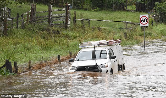 A vehicle attempts to navigate flood waters in the town of Tintenbar on April 4, 2024 in Byron Bay, Australia.
