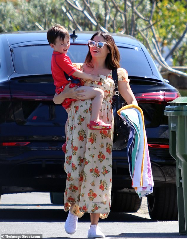 The soon-to-be mother of three, 43, showed off her baby bump in a long floral dress and sneakers with white sunglasses.