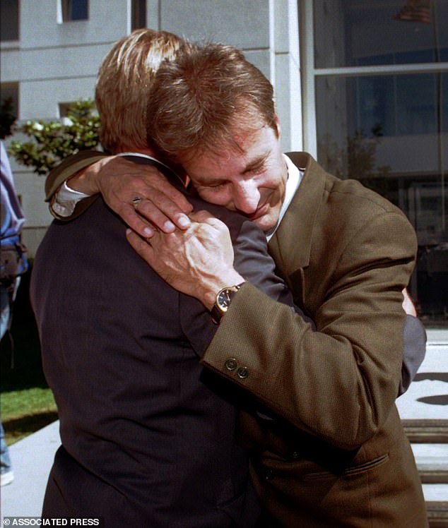 Marc Klaas, father of Polly Klaas, hugs an unidentified friend after Davis was sentenced