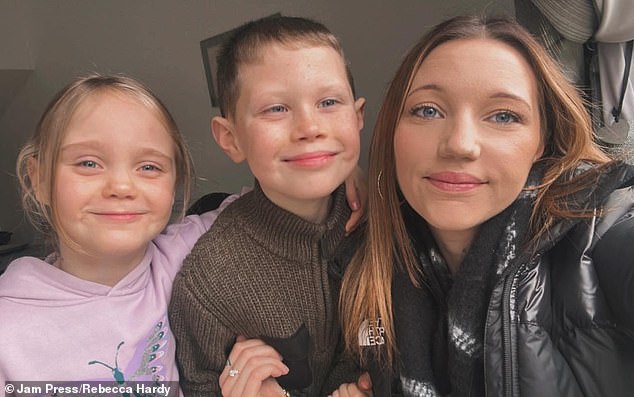 Ms Hardy (right), mother of six-year-old Lexxie (left) and seven-year-old Dexter (centre), said she did not want to risk surgery to remove it.