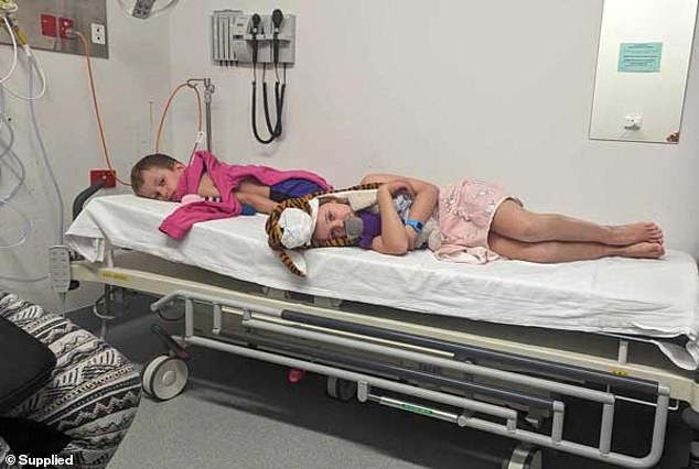 Max and his friend Cassie are pictured on a hospital cart while being treated for daisy burns.