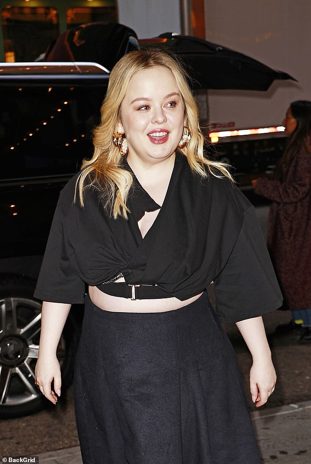 The Bridgerton star showed off her gorgeous figure in a quirky black crop top that featured pleated details and a plunging neckline.