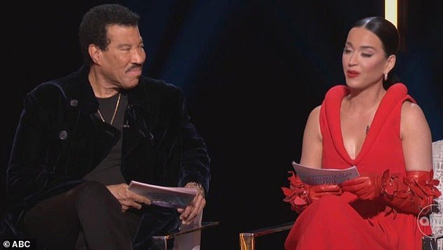 The 39-year-old pop artist wowed the audience during the broadcast in a $7,400 Bottega Veneta dress that plunged to flaunt her voluptuous assets;  Pictured with co-judge Lionel Richie.